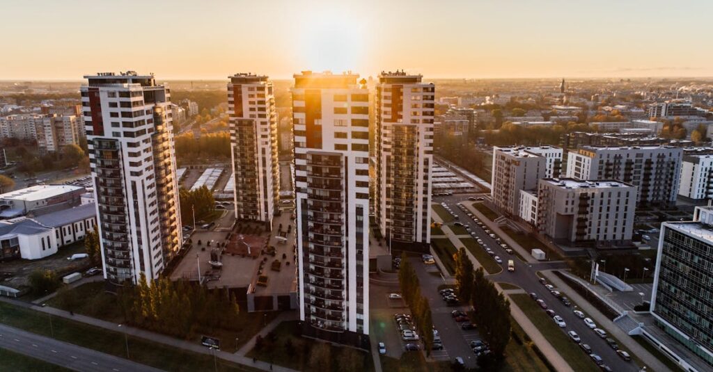 Captivating high-rise buildings silhouetted by a setting sun in a bustling cityscape.